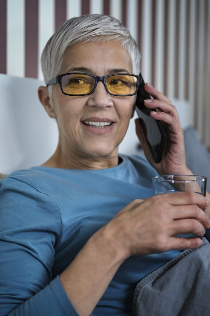 Blue-Light Blocking Glasses. Mature Woman Talking over the Phone