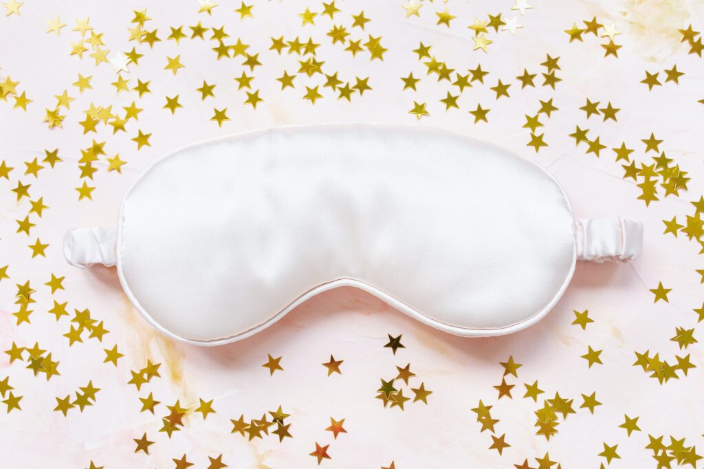 Pink satin eye sleeping mask and golden stars